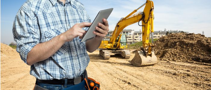 Worker using a tablet in a construction site